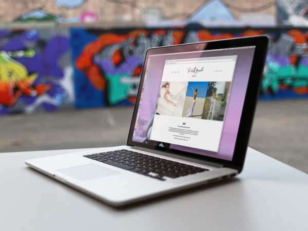 MacBook in front of Wall Mockup