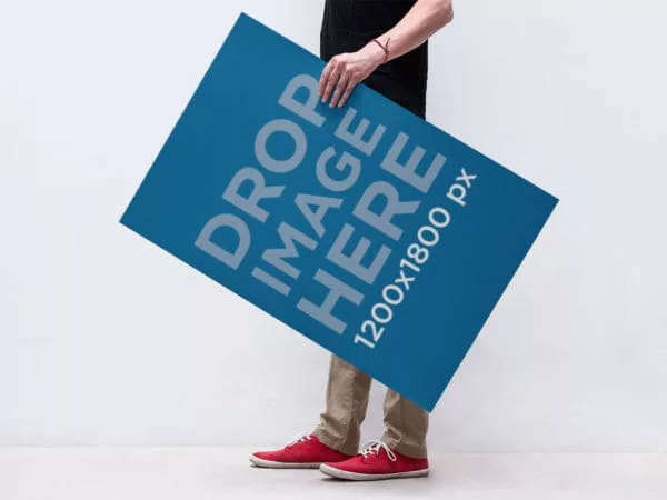 Man Holding a Poster – Free PSD Mockup