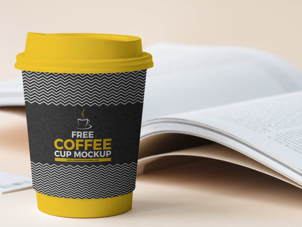 Free Coffee Cup Beside Book Mockup 2018