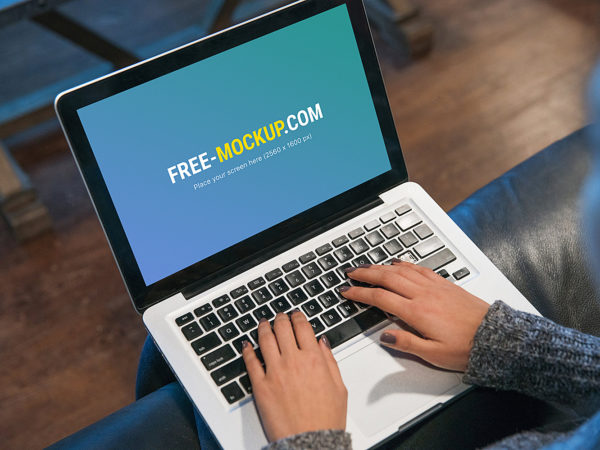 Young Lady Typing Code on MacBook Pro Mockup