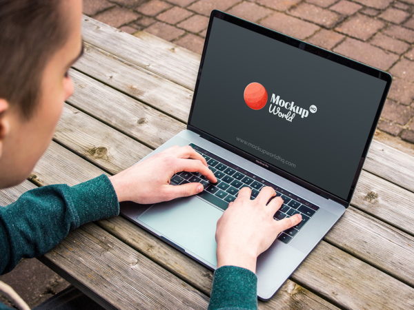 Man Typing on MacBook Pro Mockup Free