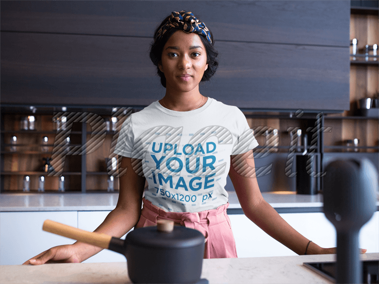 woman-wearing-a-round-neck-tshirt-mockup-while-in-her-kitchen-counter-orig
