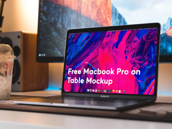 Free MacBook Pro on Table Workspace Mockup
