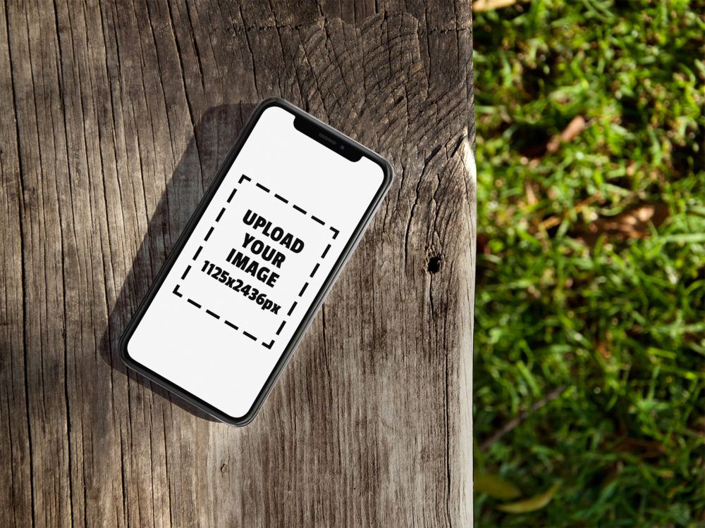 iPhone X Mockup Lying on a Wooden Bench Outdoors