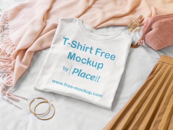 Folded T-Shirt Mockup Surrounded by Girly Garments