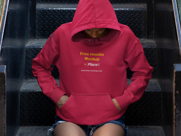 Hoodie Mockup of a Young Woman Sitting on Some Steps