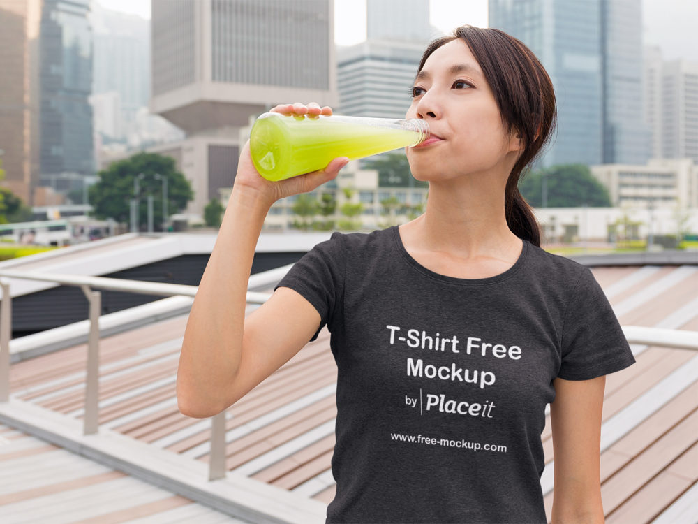 Placeit Free TShirt Mockup of a Woman Drinking Juice