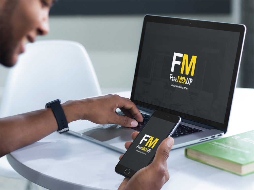 Man Working on His Macbook Pro Laptop and iPhone Placeit Mockup