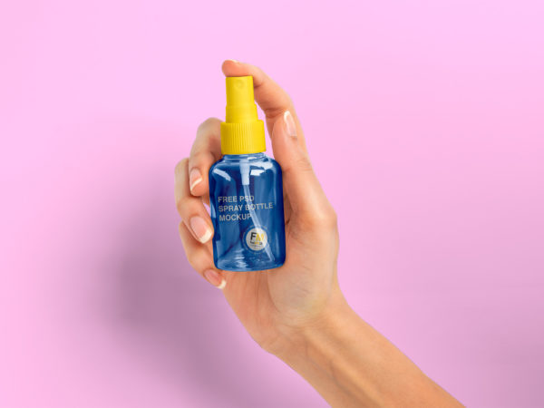 Free Spray Bottle in Woman Hand Mockup PSD