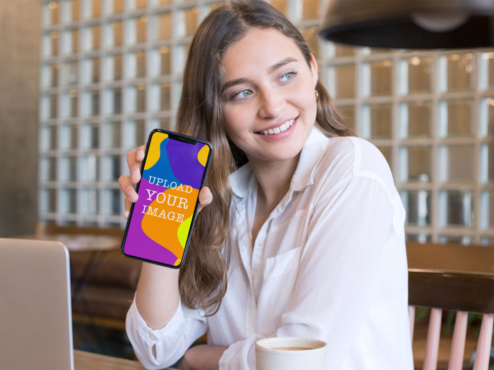 iPhone Free Mockup in Hand of a Smiling Girl