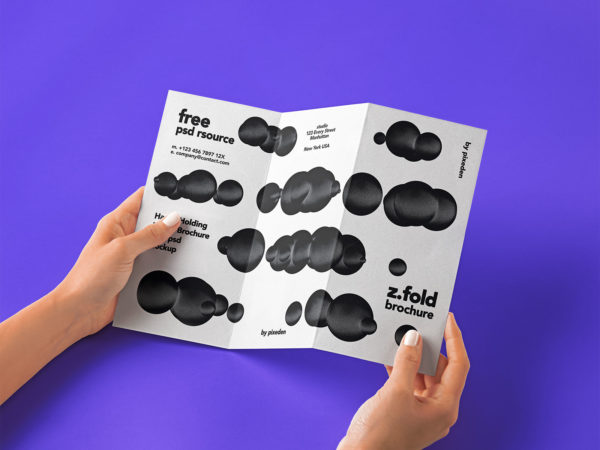 Hand Holding Tri-Fold Brochure Free PSD Mockup