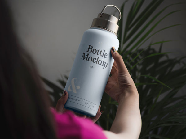 Woman Holding Bottle Mockup Free PSD