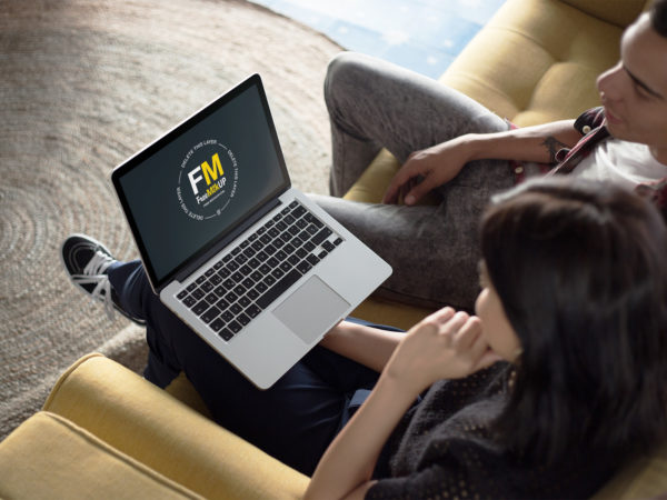 Coworkers Working on a MacBook Mockup