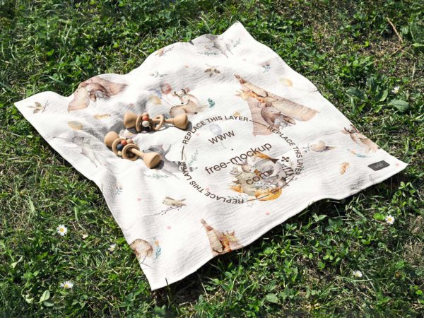 Free Cotton Muslin Swaddle Blanket Mockup on the Grass