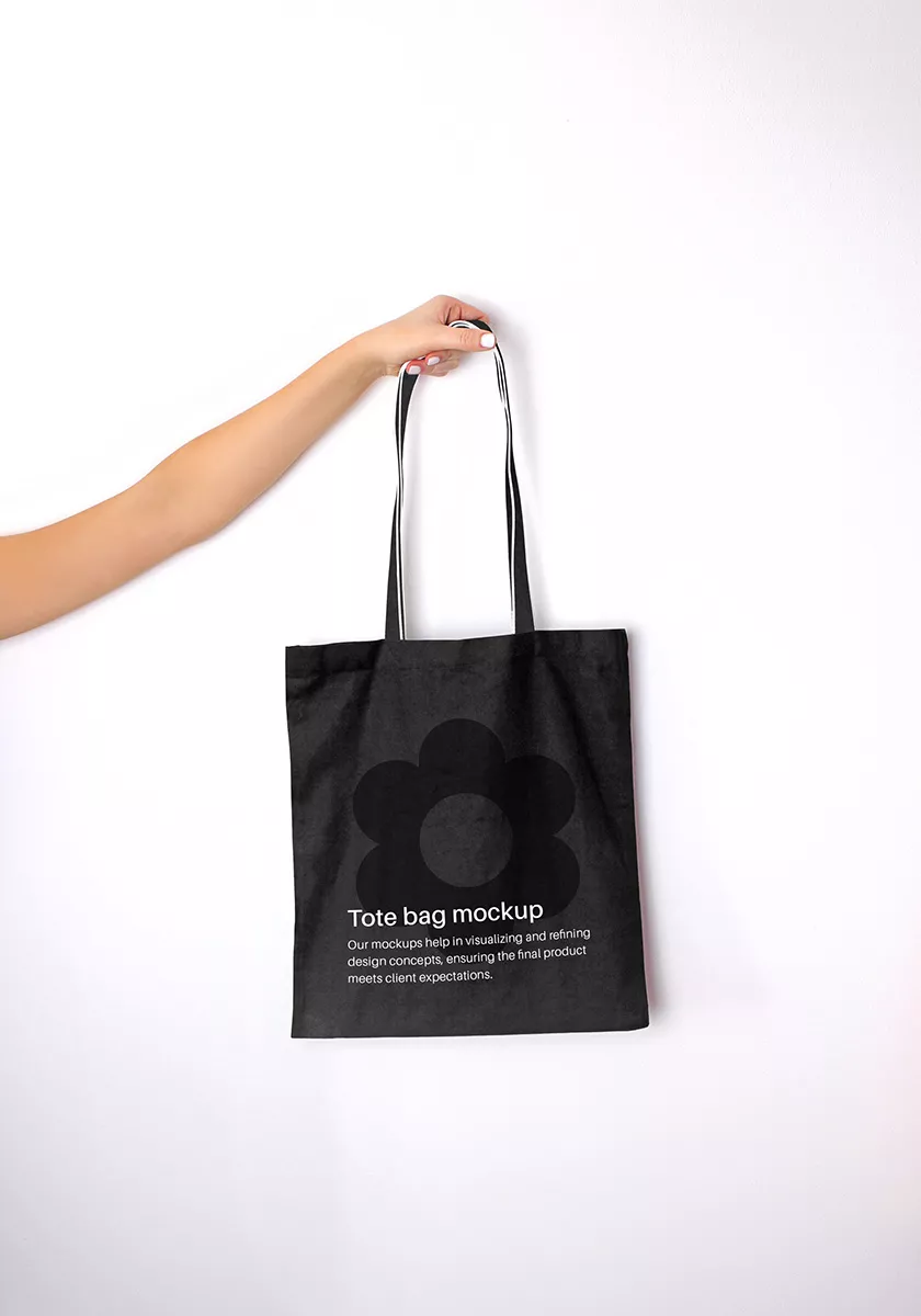 Hand holding tote bag mockup