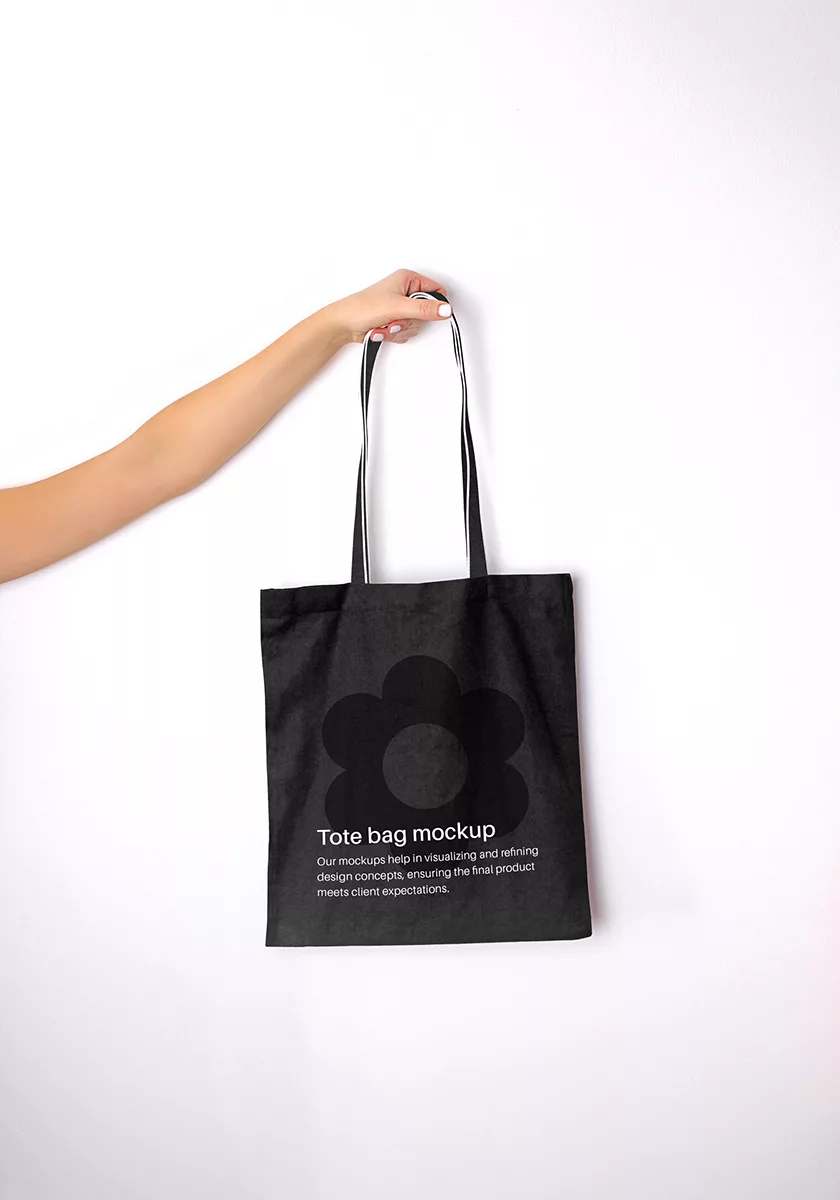 Hand holding tote bag mockup