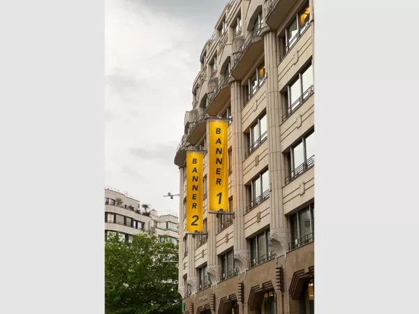 Two vertical banner flag mockups on a building