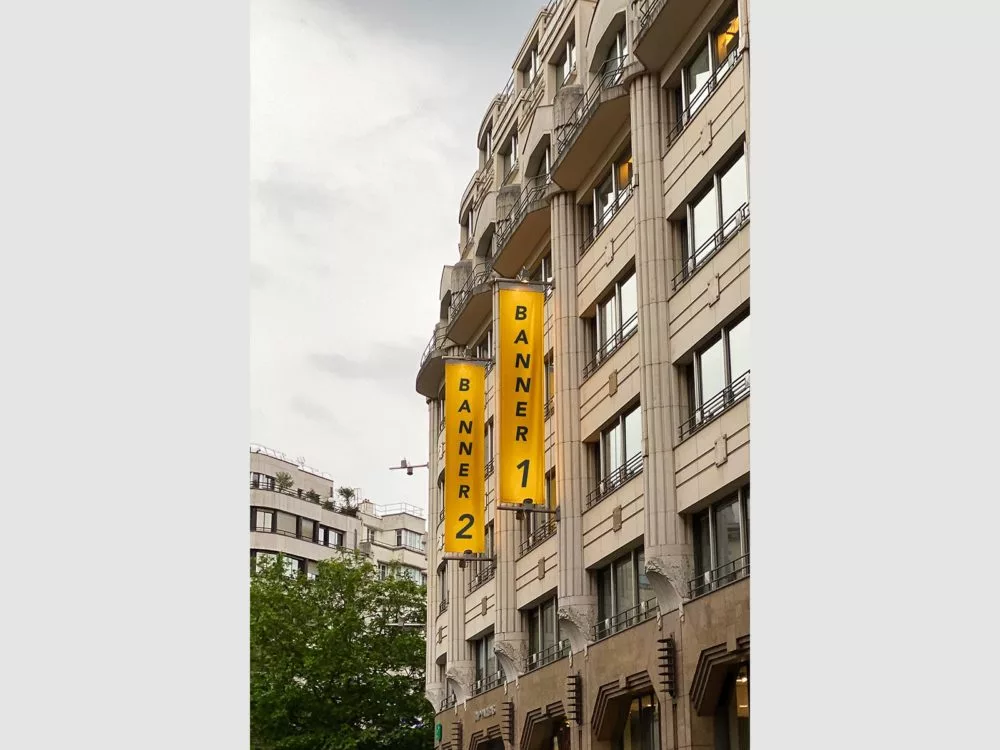 Two vertical banner flag mockups on a building