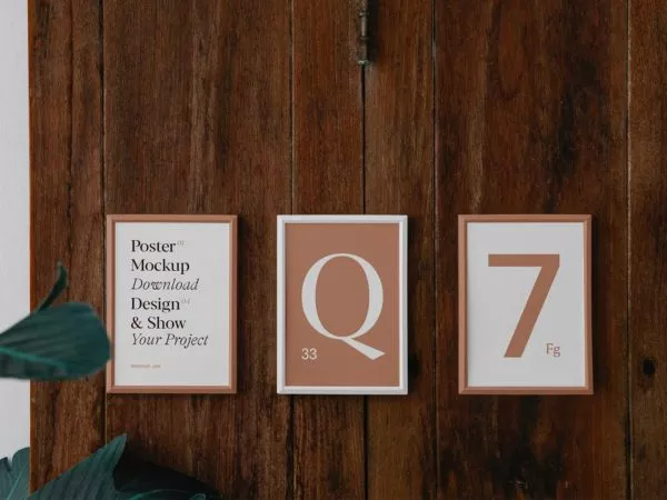 Three poster frame mockups on wood wall