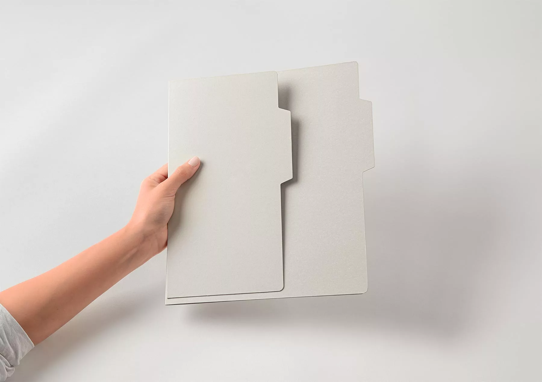 Hand Holding Stationery Folder Mockups