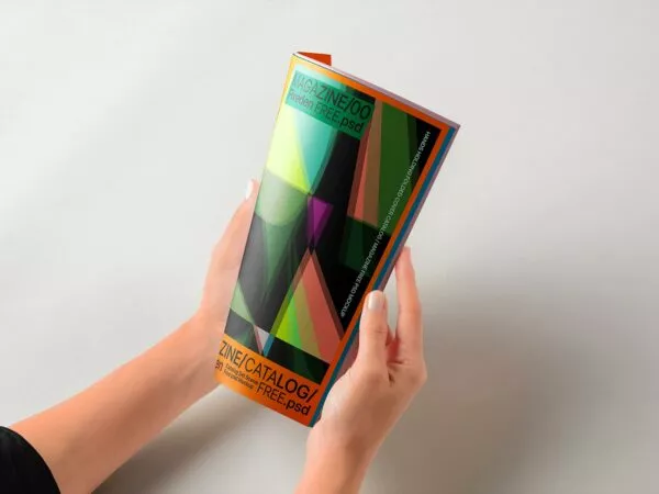 Hands Holding Folded Magazine Mockup