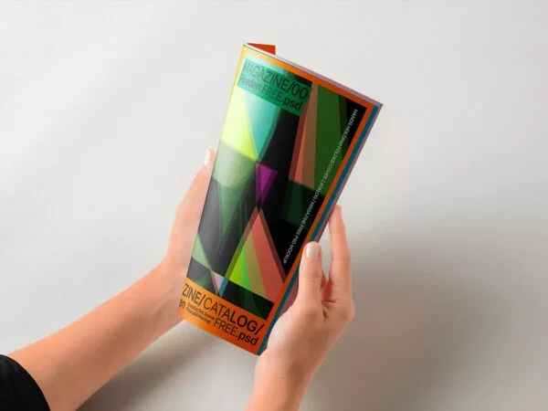 Hands Holding Folded Magazine Mockup