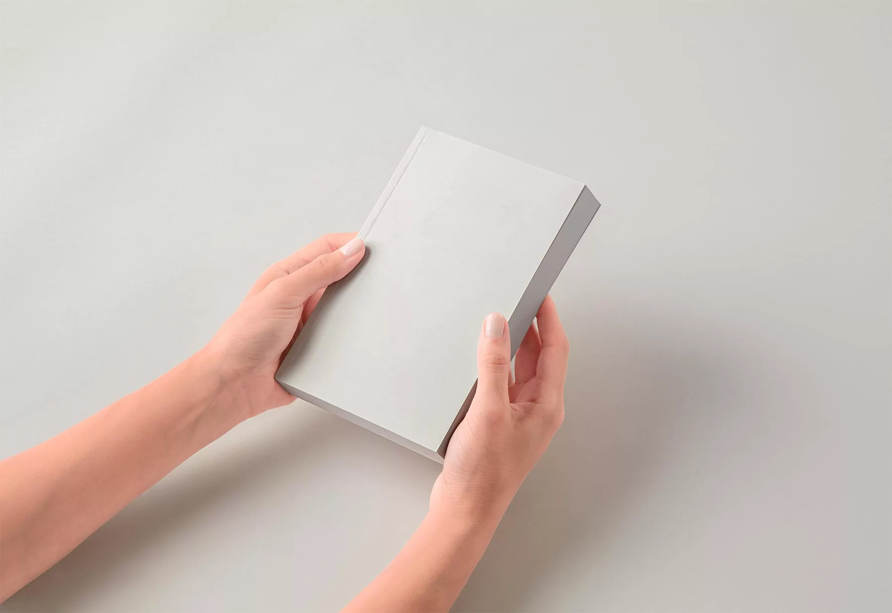 Hands Holding Paperback Book Cover Mockup