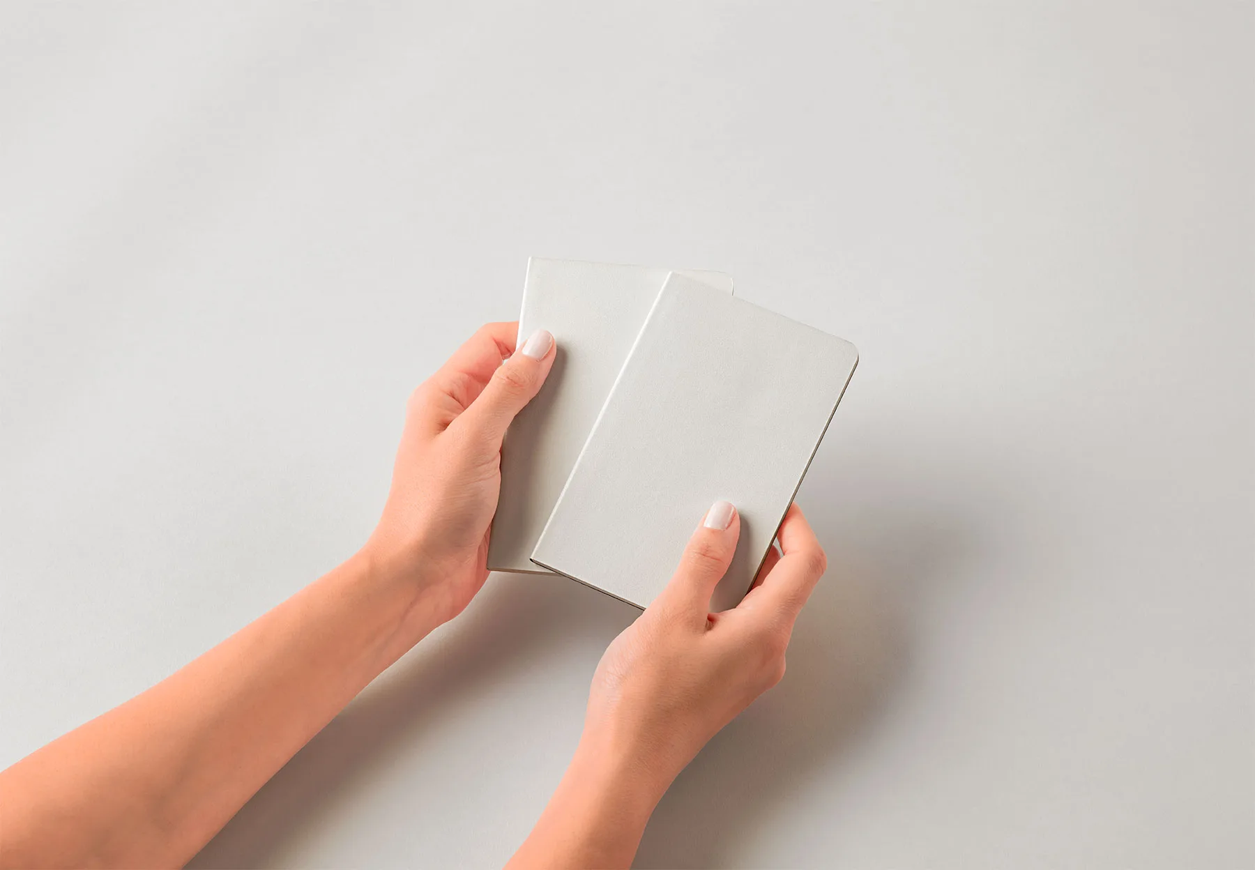 Hands Holding Pocket-Size Notebook Mockup