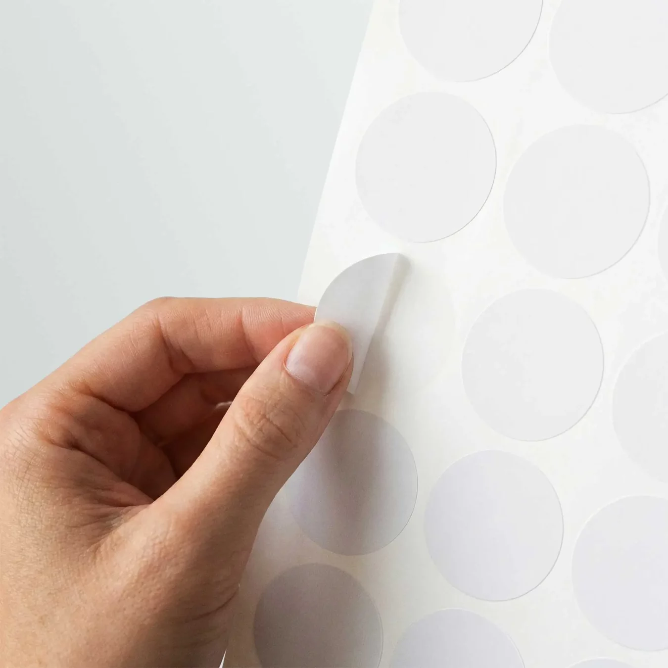 Round Sticker Sheet Mockup in Hand