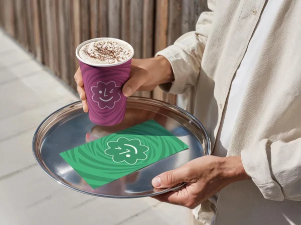 Free Paper Coffee Cup Mockup in Hand (Barista Tray Scene)