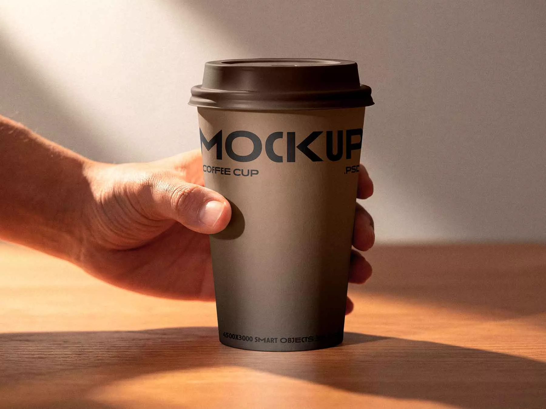 Coffee Cup in Hand Mockup (Free Download)