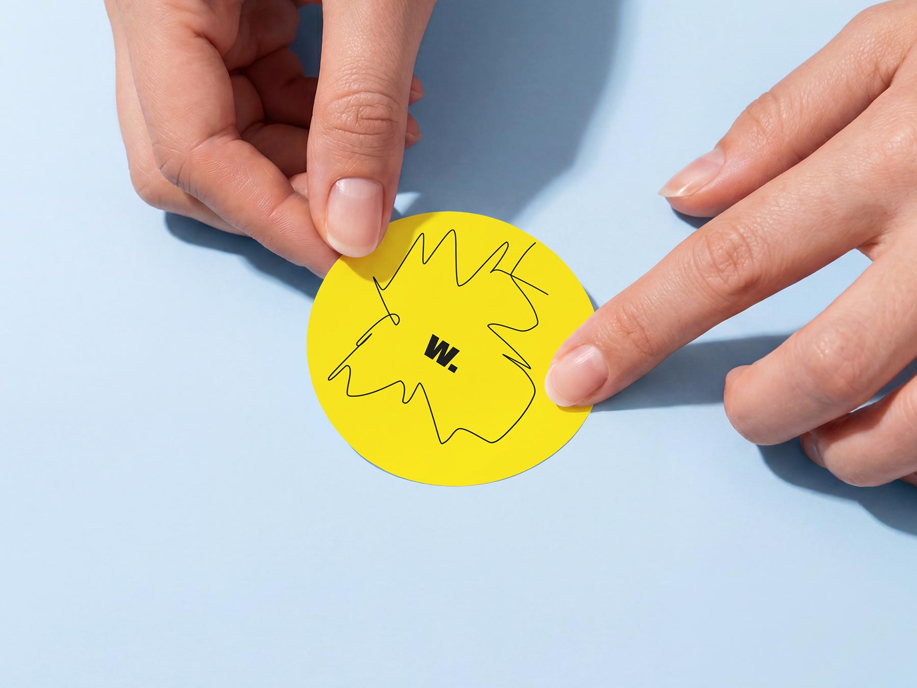 Free Round Sticker in Hands Mockup (PSD Download)