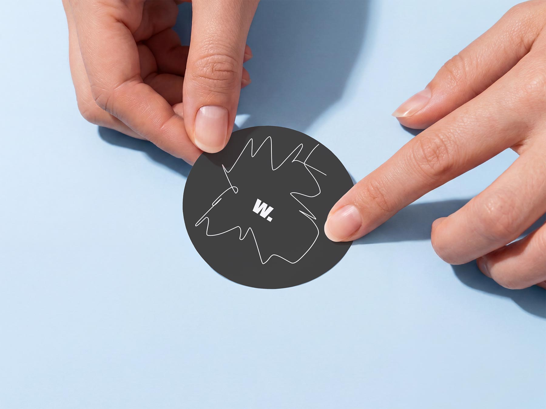 Free Round Sticker in Hands Mockup (PSD Download)