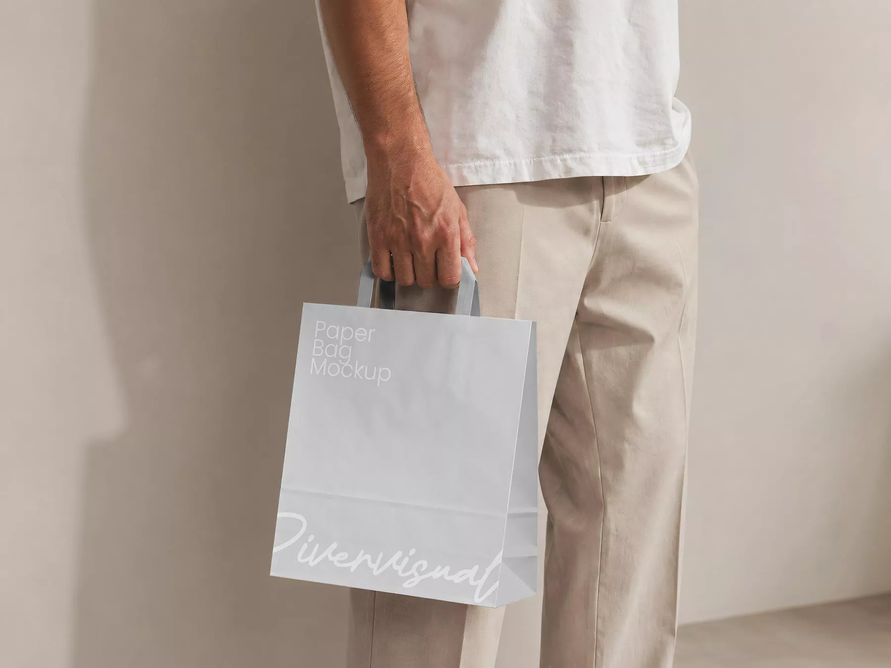 Free Man Holding Paper Shopping Bag Mockup