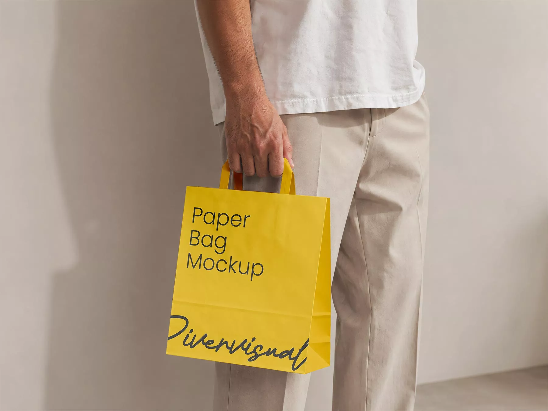 Free Man Holding Paper Shopping Bag Mockup