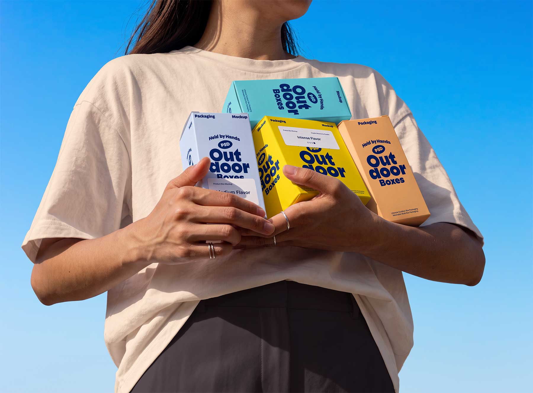 Person Holding Multiple Product Boxes Free Mockup