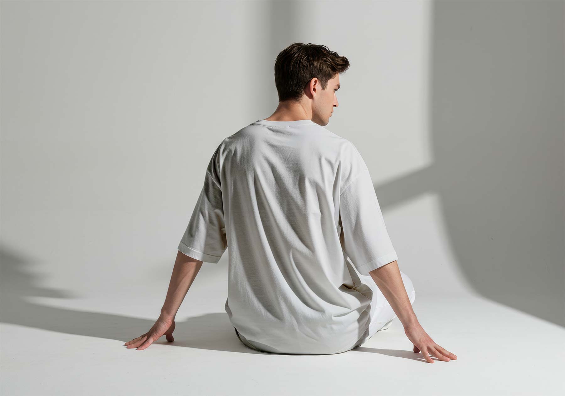 Man Sitting in Oversized T-Shirt Back View Mockup